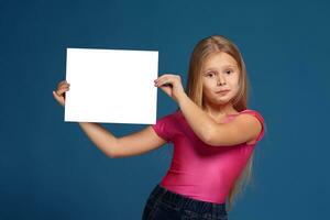 Portrait of adorable emotional little girl on blue background photo