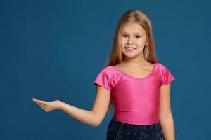 Portrait of adorable emotional little girl on blue background photo