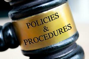 Policies and Procedures text engraved on gavel. Policies and procedures concepts photo