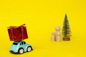 Mother, daughter, and son eagerly await their father return for Christmas with present photo