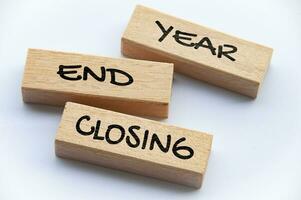 Top view of Year End Closing text on wooden blocks. photo