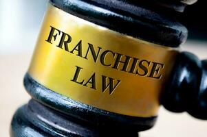 Franchise law text engraved on gavel. Franchise law and legal concept photo