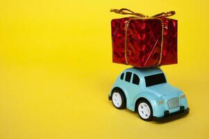 Toy car carrying present in red with customizable space for text photo