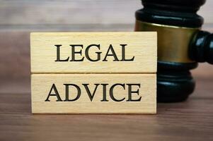 Legal Advice text on wooden blocks with gavel background. Legal Advice concept photo