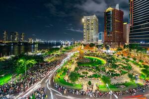 Ho Chi Minh city, Vietnam - Sep 2, 2023 View of Me Linh roundabout with heavy traffic near Bach Dang waterbus station port and Saigon river at blue hour photo