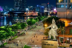 Ho Chi Minh city, Vietnam - Sep 2, 2023 View of Me Linh roundabout with heavy traffic near Bach Dang waterbus station port and Saigon river at blue hour photo