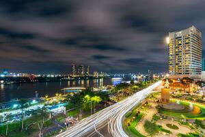 Ho Chi Minh city, Vietnam - Sep 2, 2023 View of Me Linh roundabout with heavy traffic near Bach Dang waterbus station port and Saigon river at blue hour photo