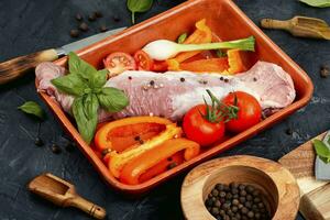 Raw uncooked meat tenderloin in a baking dish. photo