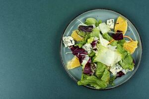 Salad with fresh greens and orange. photo