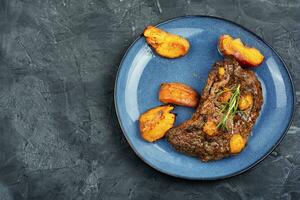 Juicy meat steak with peach. photo