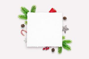 Empty paper sheet with copy space. Festive Christmas decorations in the background. Ideal for holiday messages and festive designs photo