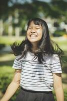 kidding face of asian teenager showns forelock hair flowing by wind photo