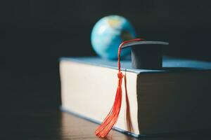 Graduated study abroad international Conceptual, Graduation hat on top Earth globe model map.Congratulations to graduates, Studies lead to success in world wide.Back to School. credited world by NASA photo