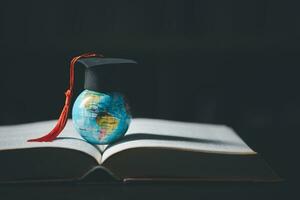 Graduated study abroad international Conceptual, Graduation hat on top Earth globe model map.Congratulations to graduates, Studies lead to success in world wide.Back to School. credited world by NASA photo