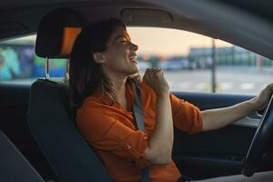 Close-up portrait of her she nice-looking attractive lovely brunette charming glad cheerful cheery girl riding new car enjoying having fun listening music singing pop rock photo