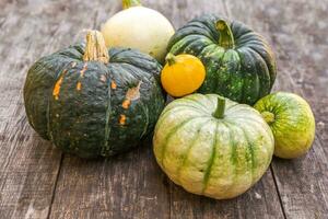 Autumnal Background. Natural autumn fall view pumpkins on wooden background. Inspirational october or september wallpaper. Change of seasons ripe organic food concept, Halloween party Thanksgiving day photo