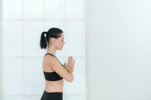 Beautiful young woman practicing yoga at home. Yoga asana. photo