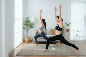 Young woman practicing yoga with instructor in house. Individual yoga class practicing in house photo