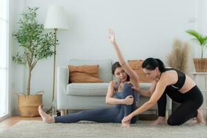 Yoga instructor assisting pupils in doing yoga poses in the studio, Yoga class concept photo