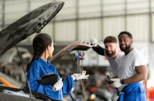 Car mechanic working in an auto repair shop, inspecting the operation of the car's air conditioner and refrigerant, Focus on woman photo