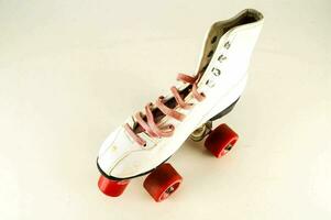 a white skateboard with red wheels and pink laces photo