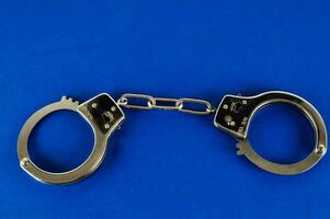 handcuffs on a blue background photo