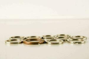 a group of metal rings on a white surface photo