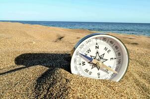 a compass on the beach photo