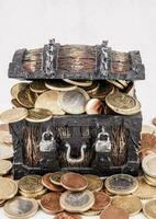 a chest full of coins on a white background photo