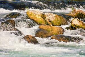 a river with rocks and water flowing over them photo