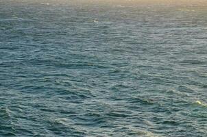 un barco es navegación en el Oceano con un grande ola foto