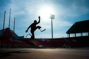 Athletes with disabilities who utilize running blades for short distances. Run down the running track. photo