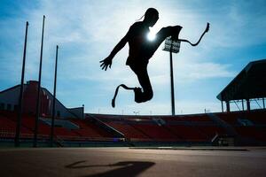 Athletes with disabilities who utilize running blades for short distances. Run down the running track. photo