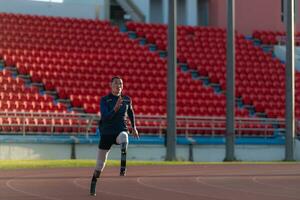 Athletes with disabilities who utilize running blades for short distances. Run down the running track. photo