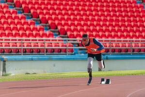 Athletes with disabilities who utilize running blades for short distances. Run down the running track. photo