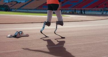 Disabled athletes with running blade used for short races on a running track. photo