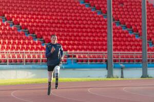 Athletes with disabilities who utilize running blades for short distances. Run down the running track. photo