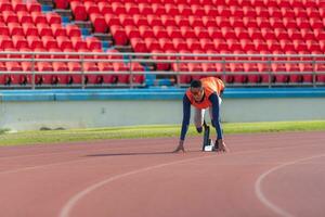 discapacitado Atletas preparar en comenzando posición Listo a correr en estadio pista foto