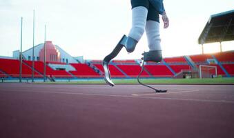 Disabled athletes with running blade used for short races on a running track. photo