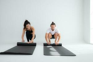 Couple doing yoga activities at home, Rolling up the yoga mat photo