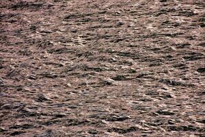 a large body of water with waves and ripples photo