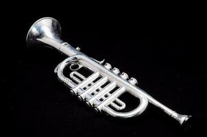 a silver trumpet on a black background photo