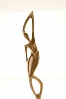 a bronze sculpture of a woman with her arms outstretched photo