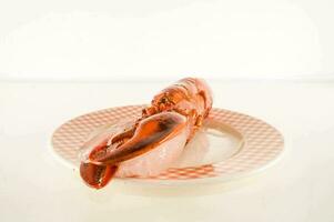 a lobster on a plate with a white background photo