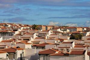 a large group of houses with red tiled roofs photo