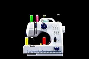 a sewing machine with many different colored threads photo