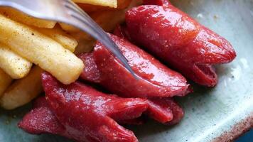 Mini Sausage served with french fries on a plate video