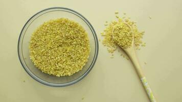 Raw Bulgur Rice on wooden spoon , video