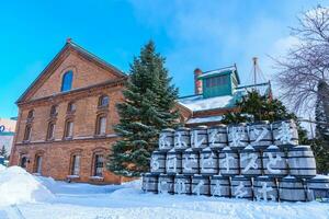 Sapporo Beer Museum with Snow in winter season. landmark and popular for attractions in Hokkaido, Japan. Travel and Vacation concept photo