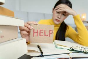 Asian student woman have anxiety because of exams, female prepare for test and learning lessons in the library. stress, despair, haste, misunderstanding reading, discouraged, expectation, knowledge photo